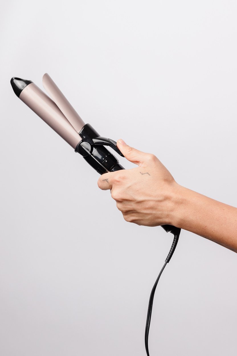 Conceptual Salon Services Hand Holding Curling Iron